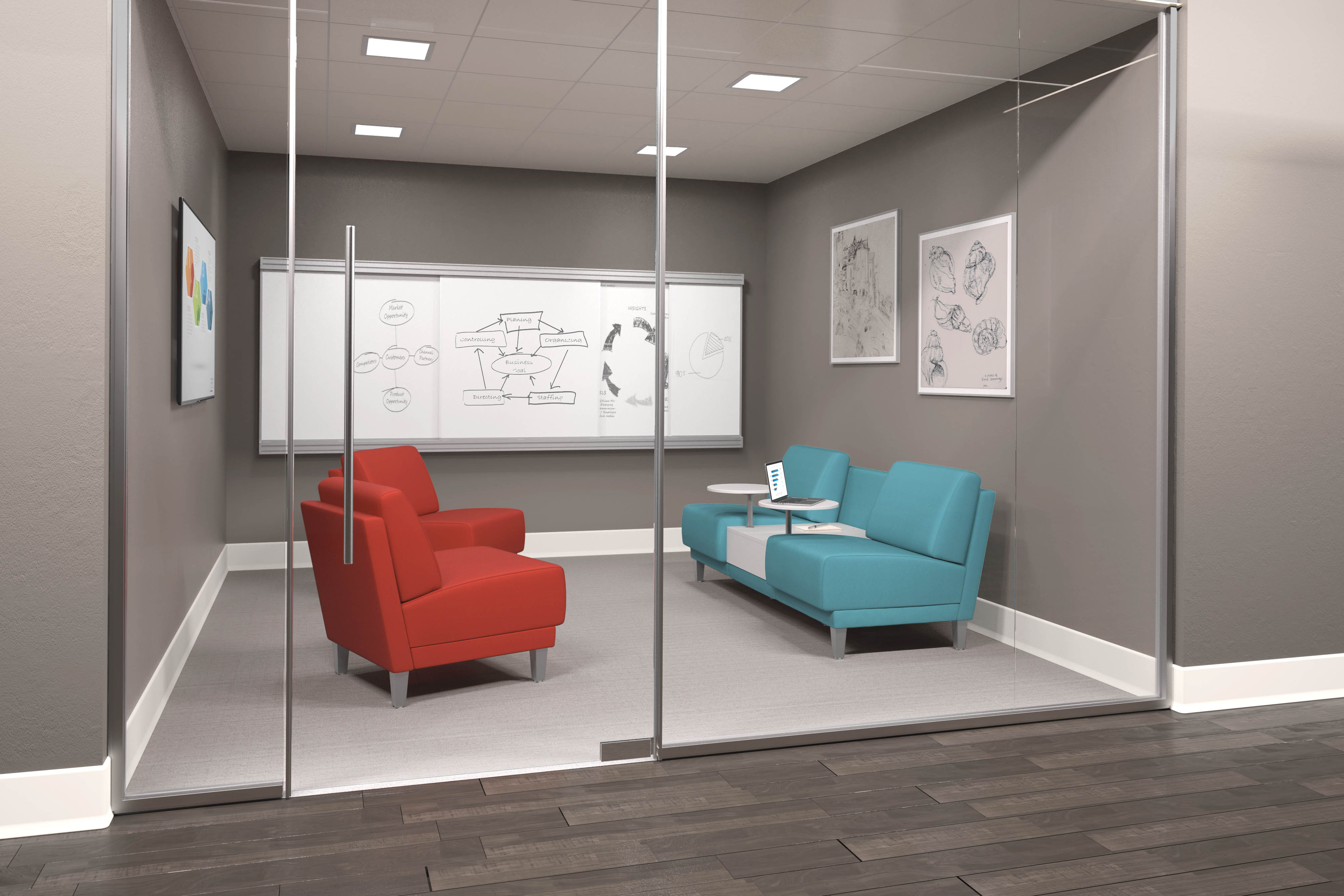 HON Grove lounge furniture in a private training space with whiteboards on the back wall. There are two red armless Grove lounge chairs with silver metal legs and a two seat Grove lounge with bright blue fabric. The two seat lounge has a built in table and tablet arms.