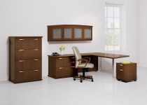 National Captivate private office with modern desking system. Separate pieces for the overhead bin, storage bin, L-shape desk and ped are separate. Laminate color is a burnt brown. Task chair is in front L shaped desk with cream colored fabric with wood base and arms.