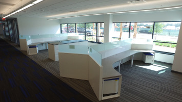 Desks in a polygon shape with panels in the middle to separate direct views of other employees in an open workspace.