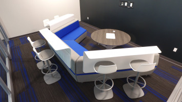 Blue and white lounge furniture with a community table to be used to collaboration purposes.