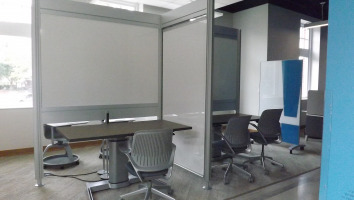 Partitions with white boards and separated for individual use.