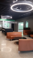 Circular lounge furniture with orange fabric and a connecting table.