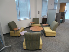 Lounge seating with tablet arms for laptop accessibility. Lounge furniture is mustard yellow seats with green backs.